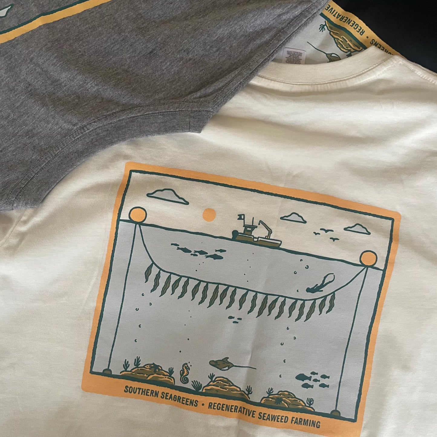 Southern Seagreens white tee shirt with seaweed kelp farm illustration with boat, diver, fish.