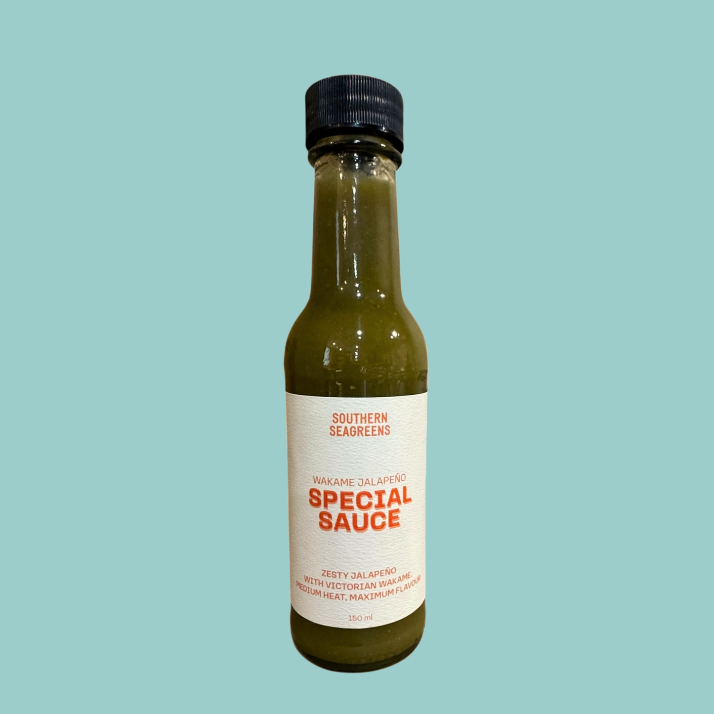 Bottle of Southern Seagreens Special Sauce on a light blue background